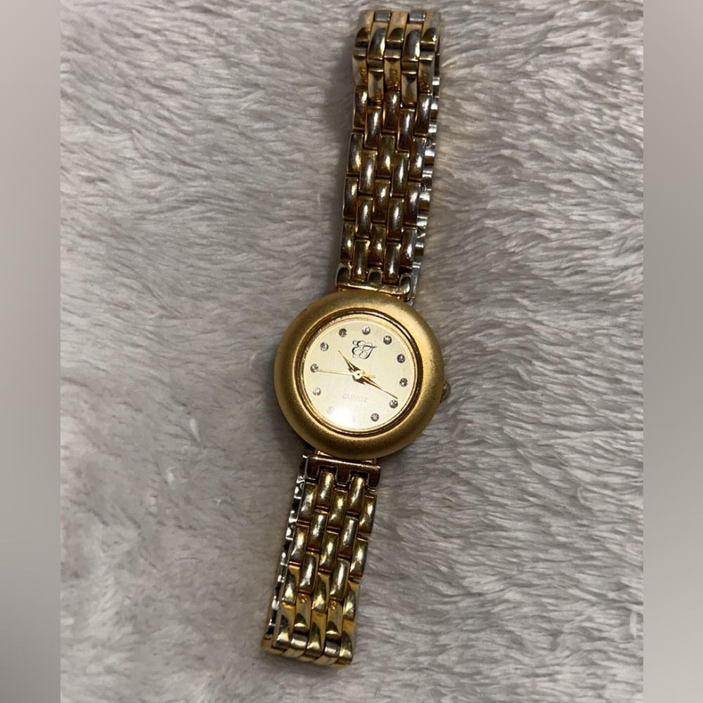 vintage Elizabeth Taylor gold-tone quartz watch with a diamond accent dial.